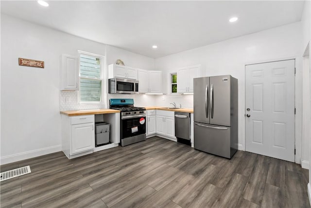 428 Card Ave, Wilmerding, PA 15148 - kitchen with stainless steel appliances, butcher block counters, white cabinets, and recessed lighting