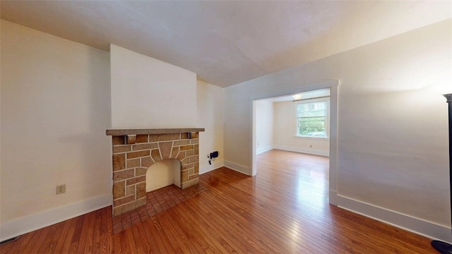 2945 Devlin St, Arlington, PA 15210 - unfurnished living room with wood finished floors and a fireplace