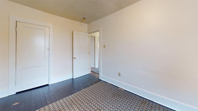 2945 Devlin St, Arlington, PA 15210 - unfurnished bedroom featuring dark wood-style flooring and baseboards