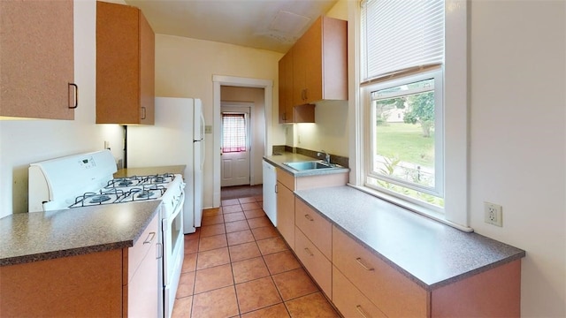 2945 Devlin St, Arlington, PA 15210 - kitchen with white gas stove, light tile patterned flooring, and dark countertops