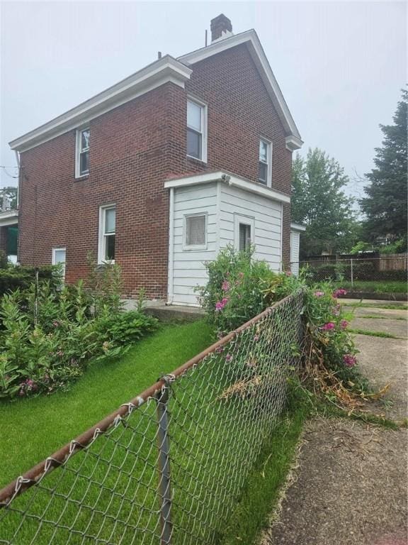 2945 Devlin St, Arlington, PA 15210 - view of side of home featuring brick siding and a chimney