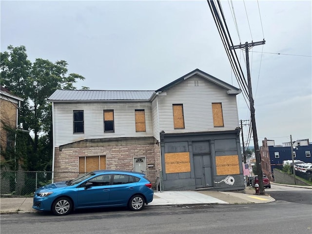 1300 Arlington Ave, Allentown, PA 15210 - view of front of house with a metal roof and stone siding