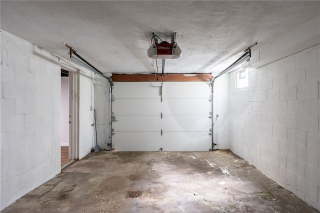 239 Pointview Rd, Brentwood, PA 15227 - garage featuring a garage door opener and concrete block wall