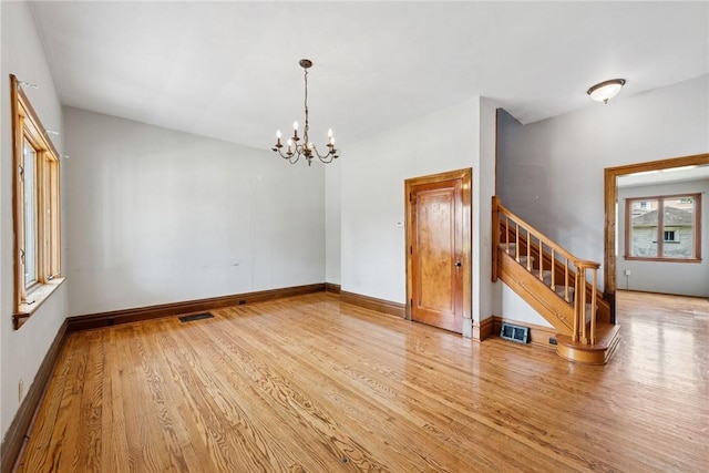 512 Alexander Ave, Southwest Greensburg, PA 15601 - spare room with light wood-style floors, a chandelier, and stairs
