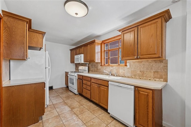 512 Alexander Ave, Southwest Greensburg, PA 15601 - kitchen with white appliances, decorative backsplash, light countertops, and brown cabinets