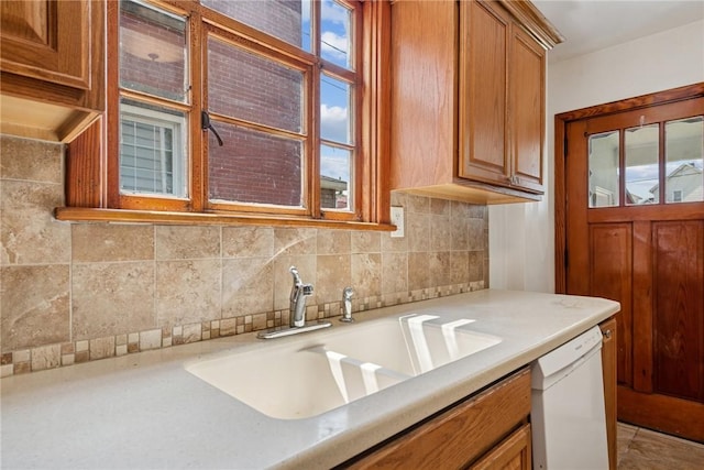 512 Alexander Ave, Southwest Greensburg, PA 15601 - kitchen featuring white dishwasher, brown cabinets, light countertops, and tasteful backsplash