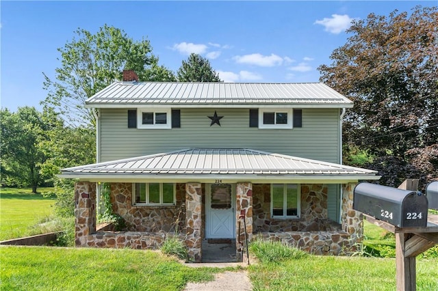224 E End, Bullskin Twp, PA 15425 - view of front of home featuring a chimney, stone siding, a metal roof, covered porch, and a front lawn