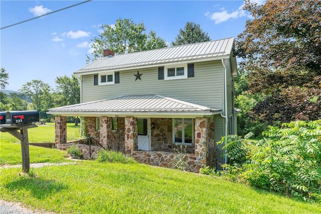 224 E End, Bullskin Twp, PA 15425 - view of front of house with a chimney, a standing seam roof, stone siding, a front lawn, and a metal roof