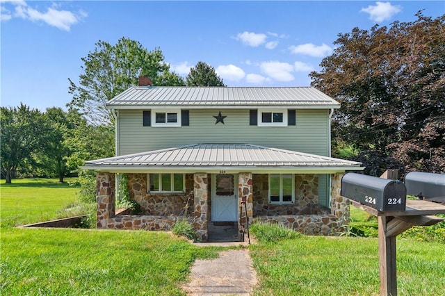 224 E End, Bullskin Twp, PA 15425 - view of front facade featuring covered porch, a chimney, a front lawn, stone siding, and a metal roof