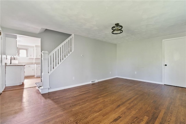 224 E End, Bullskin Twp, PA 15425 - unfurnished living room featuring wood finished floors and stairway