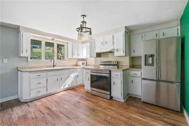 224 E End, Bullskin Twp, PA 15425 - kitchen with appliances with stainless steel finishes, light countertops, wood finished floors, and white cabinets