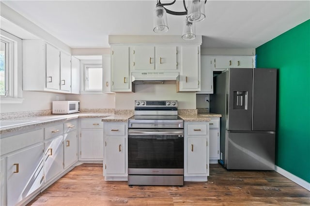 224 E End, Bullskin Twp, PA 15425 - kitchen with stainless steel appliances, under cabinet range hood, light countertops, white cabinetry, and wood finished floors