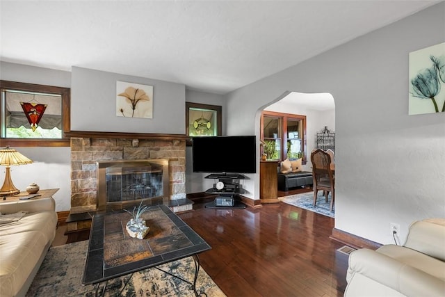 5517 Gibson Rd, Richland, PA 15044 - living room with wood finished floors, arched walkways, a stone fireplace, and healthy amount of natural light