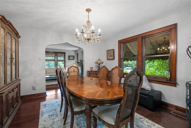 5517 Gibson Rd, Richland, PA 15044 - dining space with arched walkways, dark wood-style flooring, and a chandelier