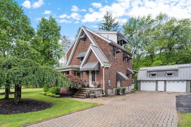 5517 Gibson Rd, Richland, PA 15044 - english style home featuring brick siding, a front lawn, an outdoor structure, and a detached garage