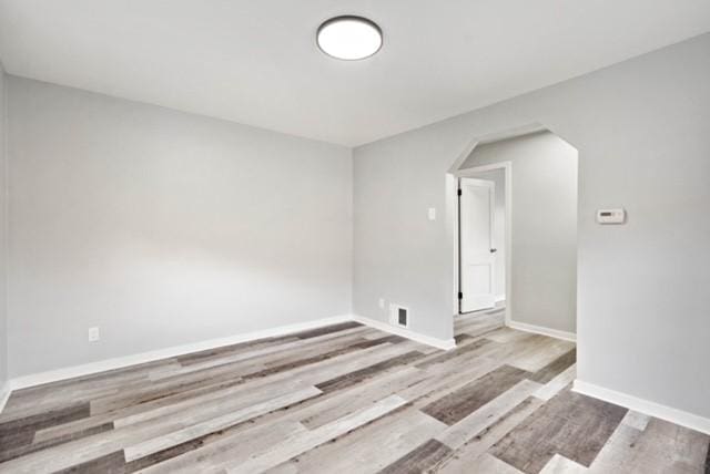 444 27th St, Mckeesport, PA 15132 - empty room with arched walkways and wood finished floors