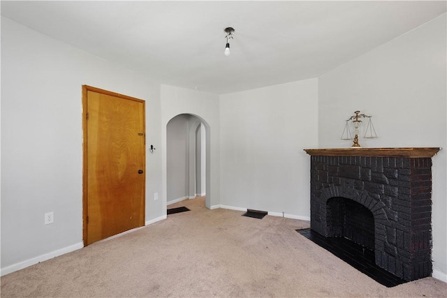 625 N Main St, City Of Washington, PA 15301 - unfurnished living room featuring arched walkways, carpet, and a brick fireplace