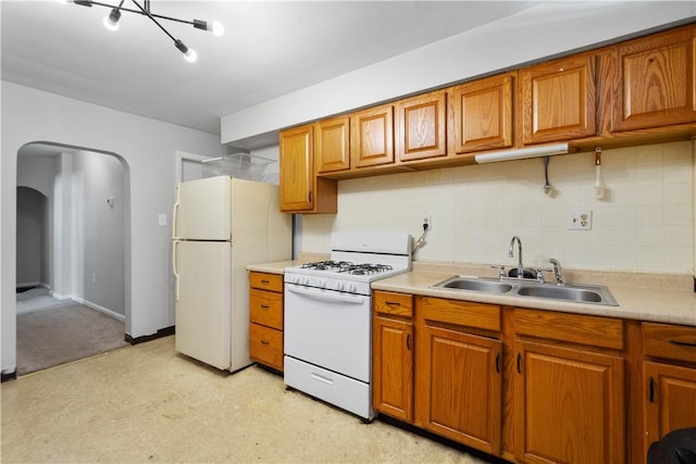 625 N Main St, City Of Washington, PA 15301 - kitchen with white appliances, brown cabinetry, and arched walkways