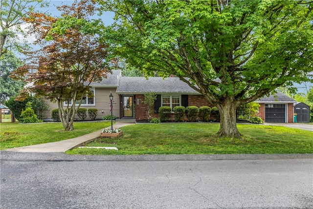 217 Westmont Rd, Ross Twp, PA 15237 - view of front of property featuring a front yard, brick siding, asphalt driveway, and a shingled roof