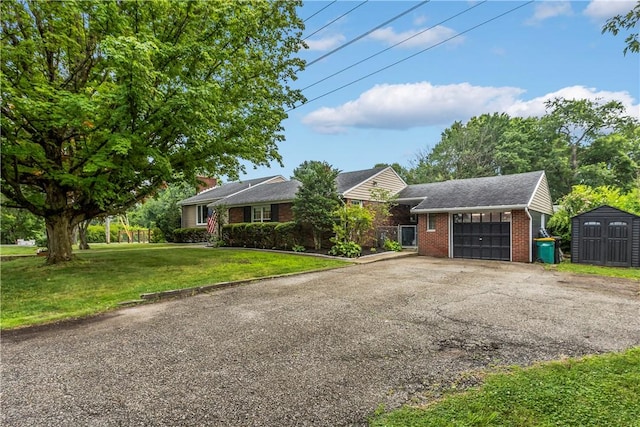 217 Westmont Rd, Ross Twp, PA 15237 - view of front of home featuring brick siding, a storage unit, asphalt driveway, an attached garage, and a front lawn
