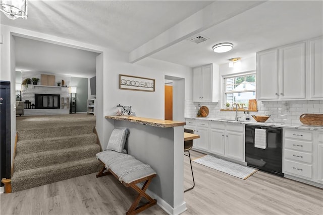 217 Westmont Rd, Ross Twp, PA 15237 - kitchen featuring dishwasher, light wood-style flooring, backsplash, white cabinetry, and a kitchen bar