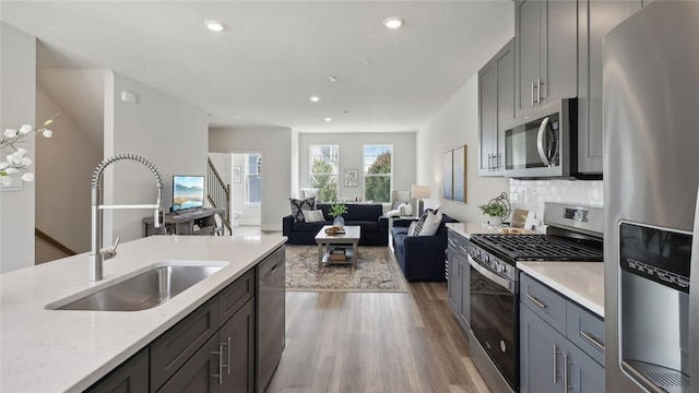 527 Cooper St Unit 3, Mccandless, PA 15090 - kitchen with stainless steel appliances, light wood-type flooring, recessed lighting, open floor plan, and gray cabinetry