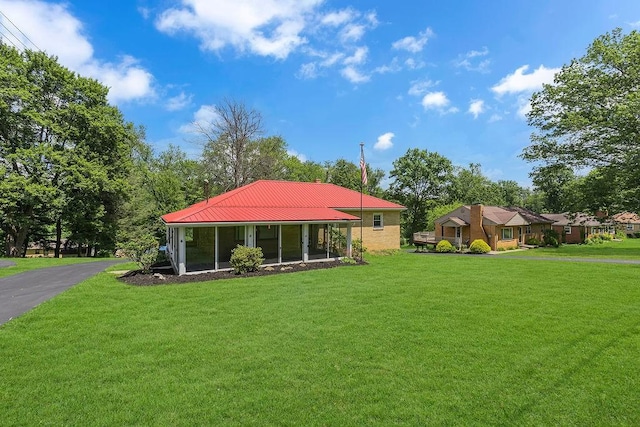 105 Eakin Dr, Brighton Twp, PA 15009 - view of front of property with a front lawn, a sunroom, and a metal roof