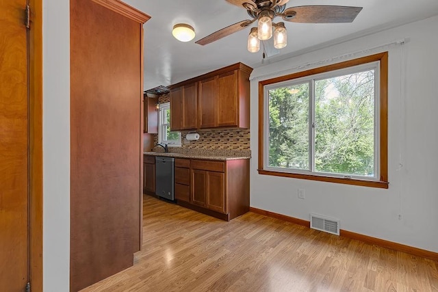 105 Eakin Dr, Brighton Twp, PA 15009 - kitchen featuring stainless steel dishwasher, light wood-style floors, decorative backsplash, a ceiling fan, and brown cabinetry