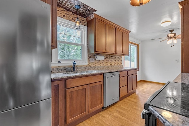105 Eakin Dr, Brighton Twp, PA 15009 - kitchen with appliances with stainless steel finishes, brown cabinets, ceiling fan, and light wood-style flooring