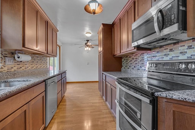 105 Eakin Dr, Brighton Twp, PA 15009 - kitchen featuring stainless steel appliances, brown cabinets, and tasteful backsplash