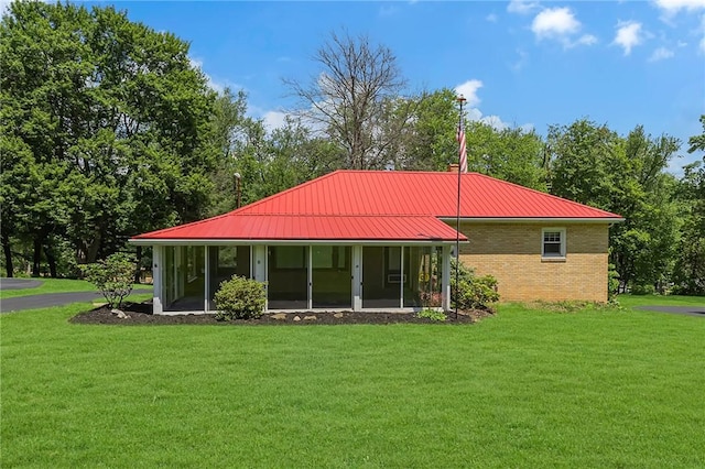 105 Eakin Dr, Brighton Twp, PA 15009 - rear view of house featuring a yard, a metal roof, and brick siding