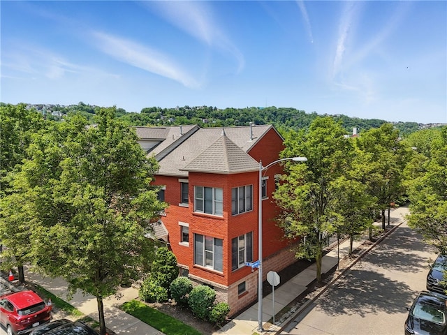 30 S 18th St, South Side, PA 15203 - view of property exterior featuring brick siding and a shingled roof