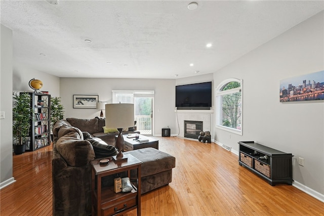 30 S 18th St, South Side, PA 15203 - living room with light wood-type flooring, a tiled fireplace, and recessed lighting