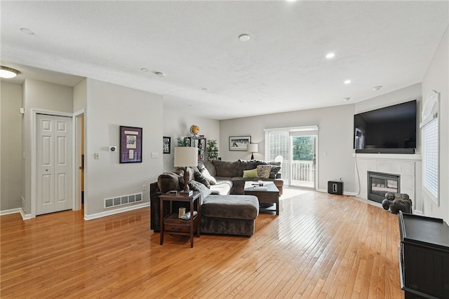 30 S 18th St, South Side, PA 15203 - living room with light wood-style floors, a tile fireplace, and recessed lighting