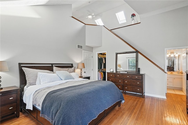30 S 18th St, South Side, PA 15203 - bedroom with a skylight, high vaulted ceiling, light wood-type flooring, a spacious closet, and ensuite bathroom