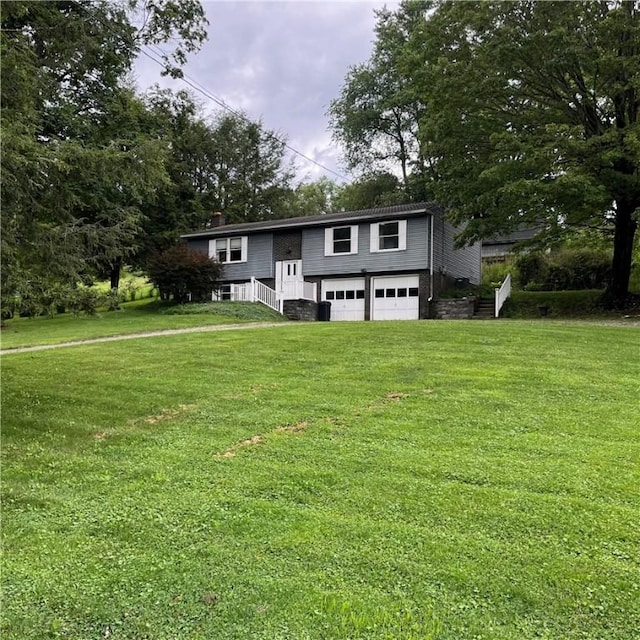 503 Bagdad Rd, Allegheny Twp, PA 15656 - split foyer home with a garage, stairway, a front yard, and driveway