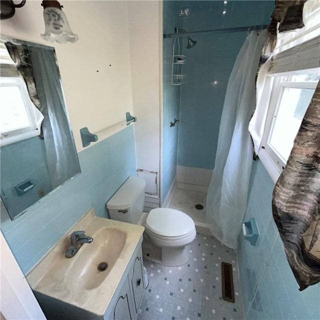503 Bagdad Rd, Allegheny Twp, PA 15656 - full bathroom featuring tile walls, a shower stall, vanity, and plenty of natural light