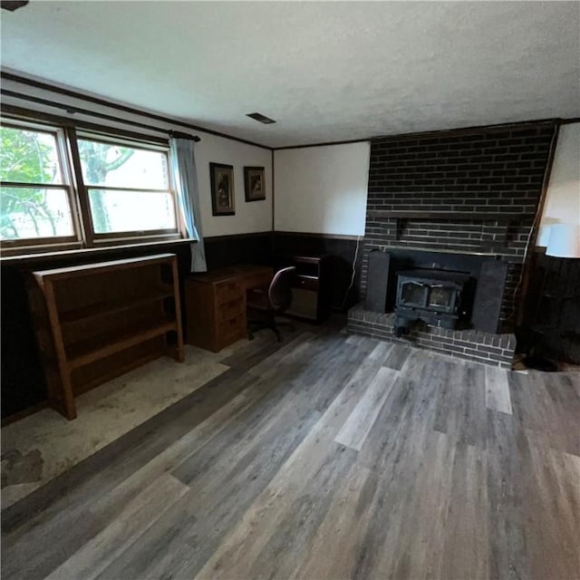 503 Bagdad Rd, Allegheny Twp, PA 15656 - home office featuring wood finished floors, a wainscoted wall, and a wood stove