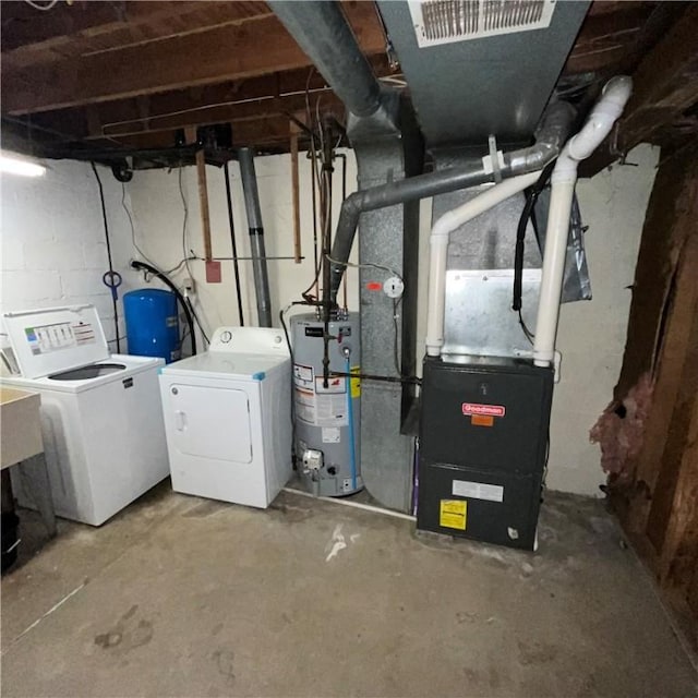 503 Bagdad Rd, Allegheny Twp, PA 15656 - unfinished below grade area featuring washing machine and dryer, water heater, and a water pressure tank
