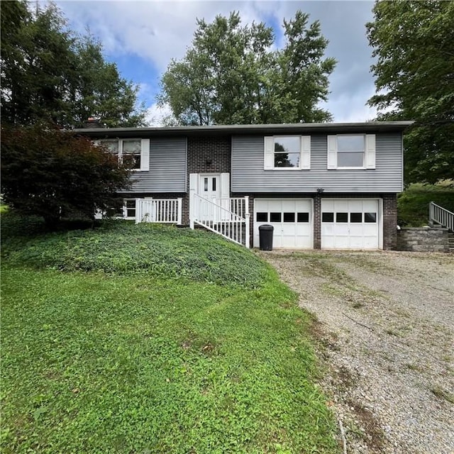 503 Bagdad Rd, Allegheny Twp, PA 15656 - split foyer home with dirt driveway, a garage, stairs, and brick siding