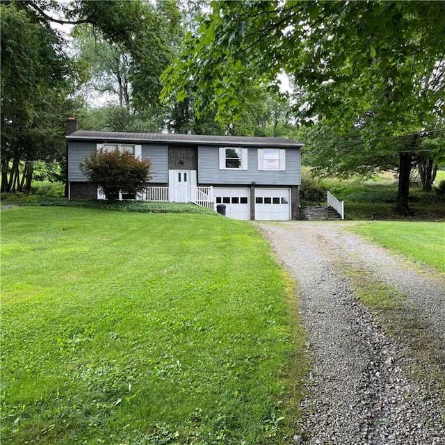 503 Bagdad Rd, Allegheny Twp, PA 15656 - bi-level home with gravel driveway, an attached garage, a chimney, and a front yard