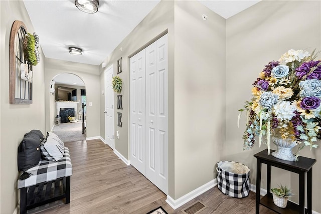 2000 Moccasin Dr, South Strabane, PA 15301 - foyer entrance with arched walkways, wood finished floors, and a fireplace