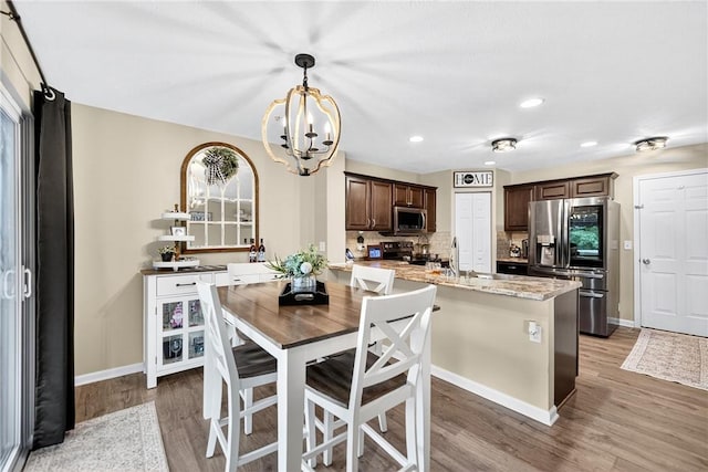 2000 Moccasin Dr, South Strabane, PA 15301 - dining area featuring light wood-type flooring, a chandelier, and recessed lighting