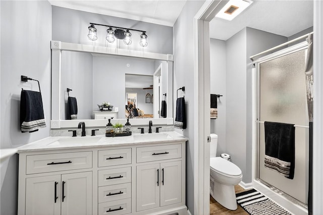 2000 Moccasin Dr, South Strabane, PA 15301 - bathroom with a stall shower, double vanity, and wood finished floors
