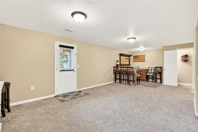 2000 Moccasin Dr, South Strabane, PA 15301 - dining area with light carpet, a textured ceiling, and bar area