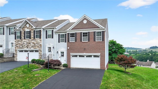 2000 Moccasin Dr, South Strabane, PA 15301 - townhome / multi-family property featuring asphalt driveway, a front yard, an attached garage, and stone siding