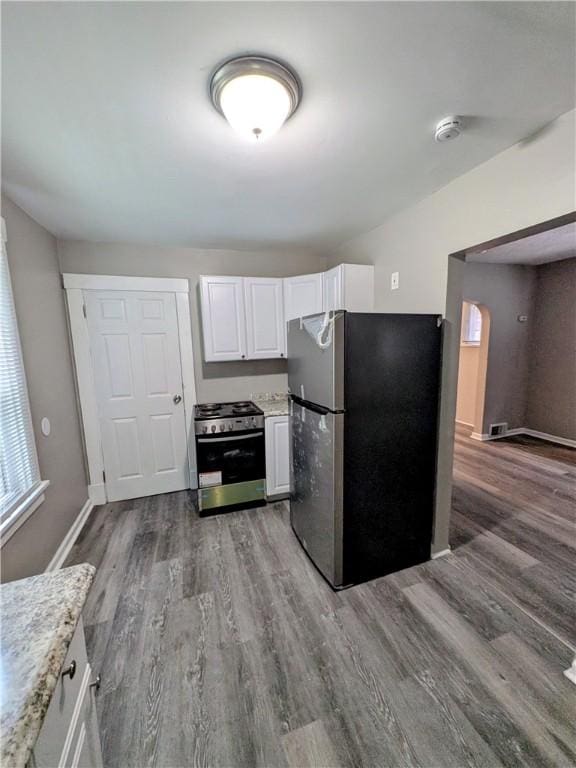 1819 Scott St, Mckeesport, PA 15132 - kitchen featuring stainless steel appliances, wood finished floors, white cabinetry, and light stone counters