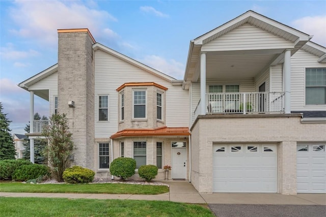 224 Adams Pointe Blvd Unit 1, Adams Twp, PA 16046 - townhome / multi-family property featuring a balcony, driveway, a chimney, and a garage