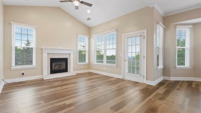 224 Adams Pointe Blvd Unit 1, Adams Twp, PA 16046 - unfurnished living room featuring wood finished floors, a ceiling fan, a glass covered fireplace, and lofted ceiling
