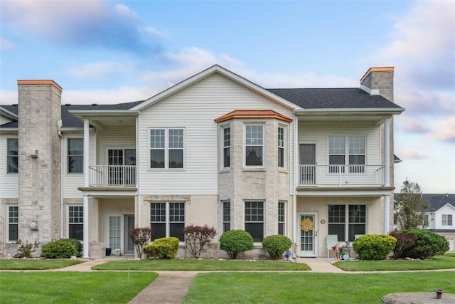 224 Adams Pointe Blvd Unit 1, Adams Twp, PA 16046 - view of front of home featuring a balcony, a front yard, and a chimney